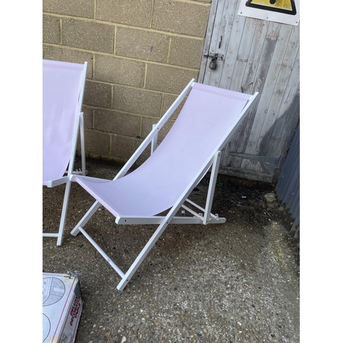 247 - A pair of white folding deck chairs and folding table