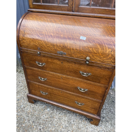 25 - A Victorian oak cylinder front oak bureau bookcase  with fitted interior 84x 50x106