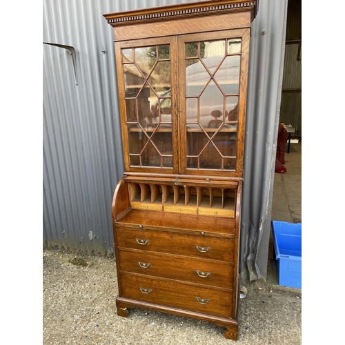 25 - A Victorian oak cylinder front oak bureau bookcase  with fitted interior 84x 50x106