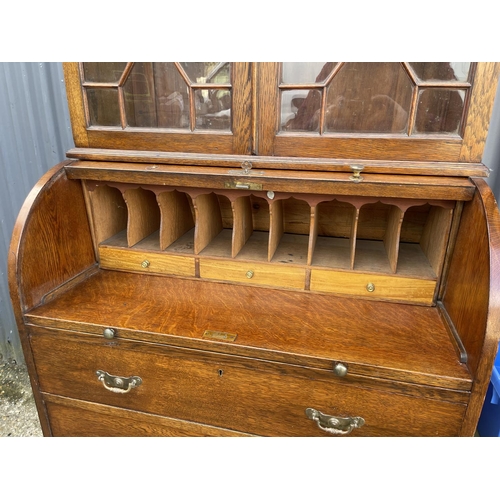 25 - A Victorian oak cylinder front oak bureau bookcase  with fitted interior 84x 50x106