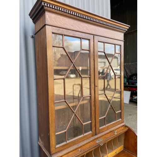 25 - A Victorian oak cylinder front oak bureau bookcase  with fitted interior 84x 50x106