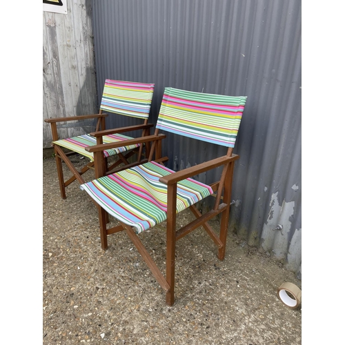 26 - A pair of hardwood folding directors style chairs with striped upholstery