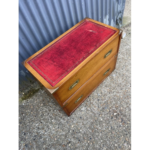 28 - A reproduction mahogany military style chest of two with red leather top  80x42x60