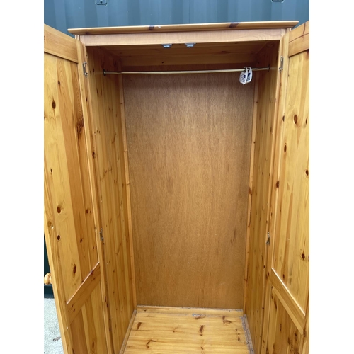 289 - A solid pine double wardrobe 84x53x190