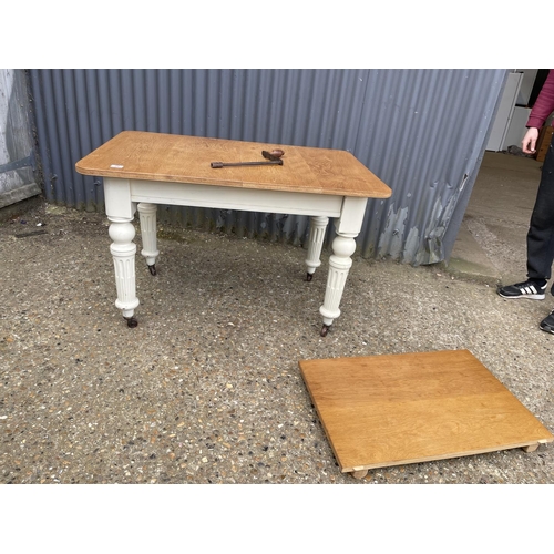 29 - A painted oak wind out dining table with extension 112x77