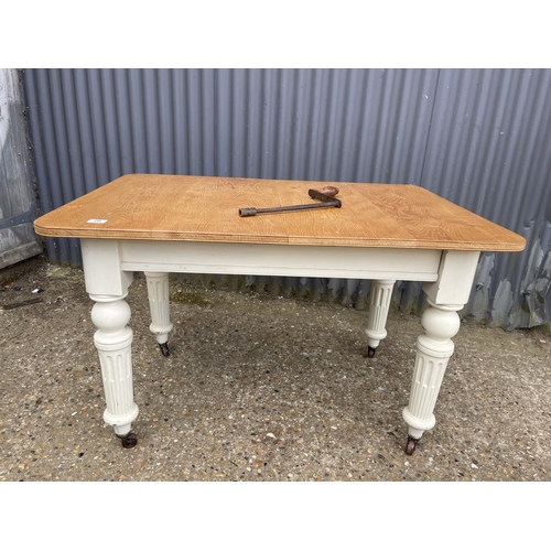 29 - A painted oak wind out dining table with extension 112x77