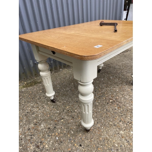 29 - A painted oak wind out dining table with extension 112x77