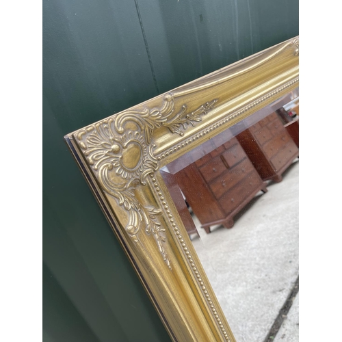 292 - A gold gilt framed mirror 77x115