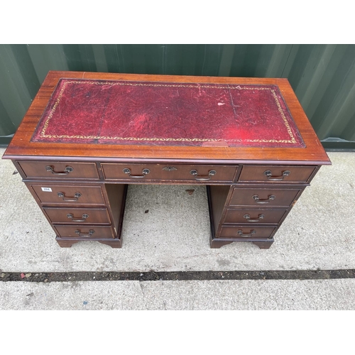 294 - A reproduction mahogany pedestal desk with red leather top