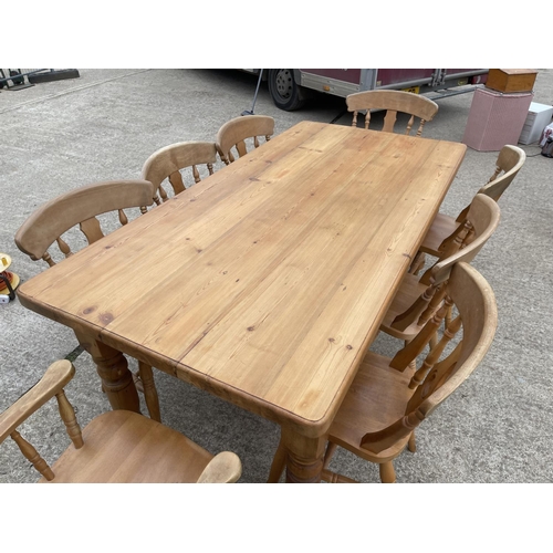 299 - A solid pine farmhouse dining table 181x90 together with a set of 8 farmhouse pine dining chairs inc... 