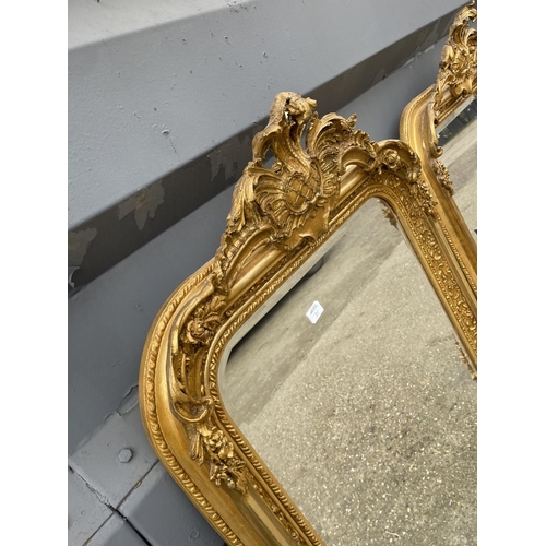 318 - A pair of very large ornate gold gilt mirrors with bevelled glass each 84x160