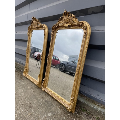 318 - A pair of very large ornate gold gilt mirrors with bevelled glass each 84x160