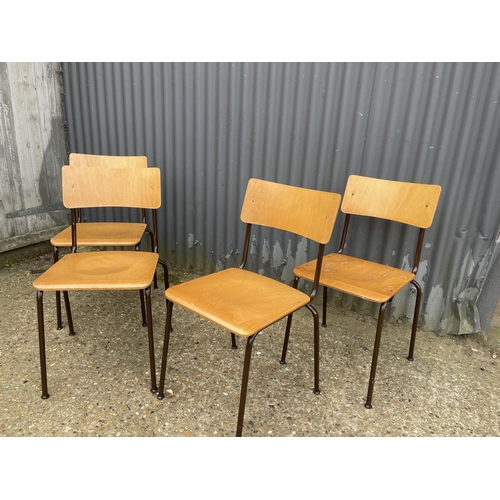 32 - A set of four retro style stacking chairs with ply seats