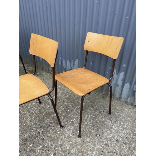 32 - A set of four retro style stacking chairs with ply seats