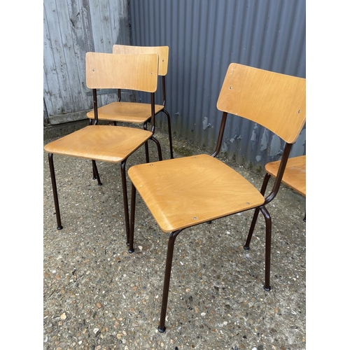 32 - A set of four retro style stacking chairs with ply seats