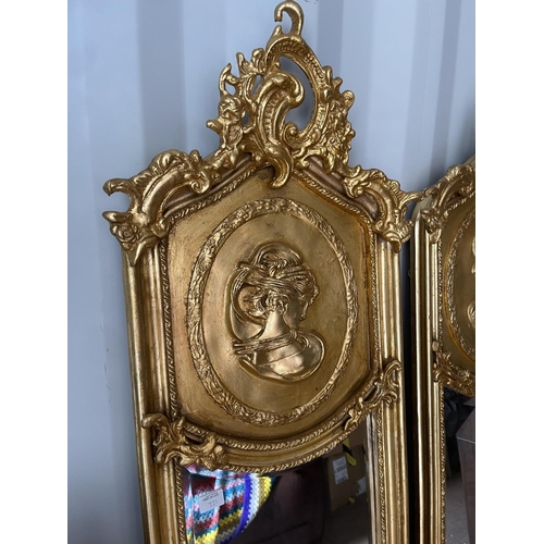 321 - A pair of gold gilt gilt framed hall mirrors each with lady head decoration facing each other each 4... 