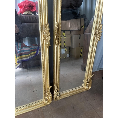 321 - A pair of gold gilt gilt framed hall mirrors each with lady head decoration facing each other each 4... 