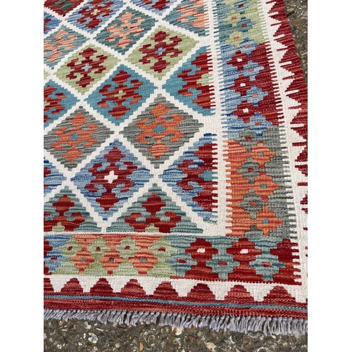 38 - A red, blue and green pattern kilim rug 192 x132