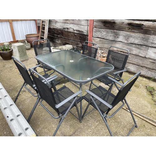 381 - Modern glass top garden table together with six folding chairs