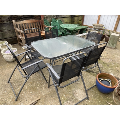 381 - Modern glass top garden table together with six folding chairs