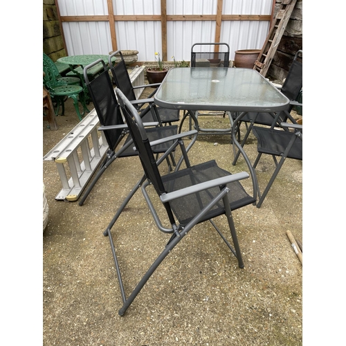 381 - Modern glass top garden table together with six folding chairs