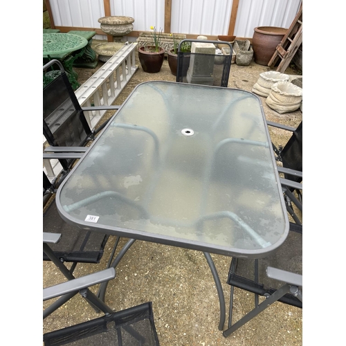 381 - Modern glass top garden table together with six folding chairs