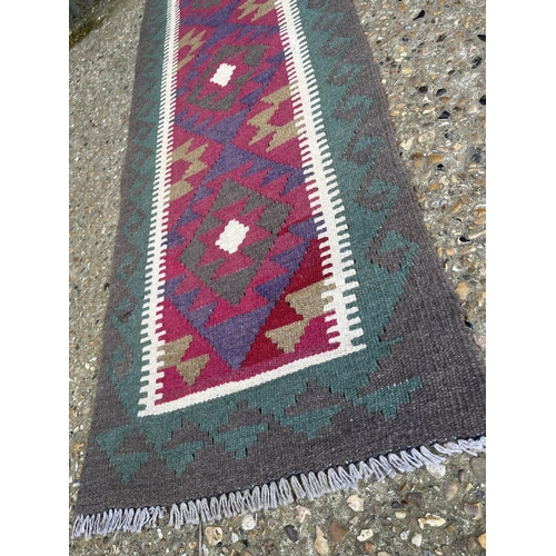 39 - A red and green kilim runner 172x 63