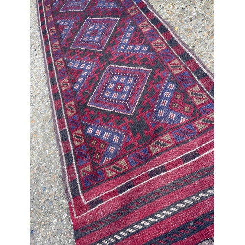 40 - A blue and red pattern runner rug 240x 63