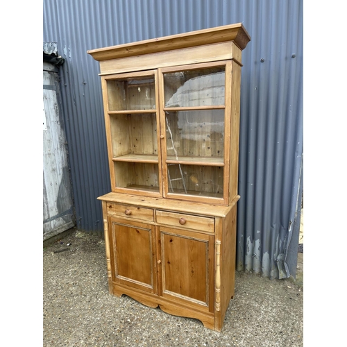 46 - A continental style pine dresser with glazed top over two drawers and two cupboard doors 110x45 x 20... 