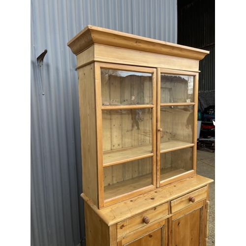 46 - A continental style pine dresser with glazed top over two drawers and two cupboard doors 110x45 x 20... 