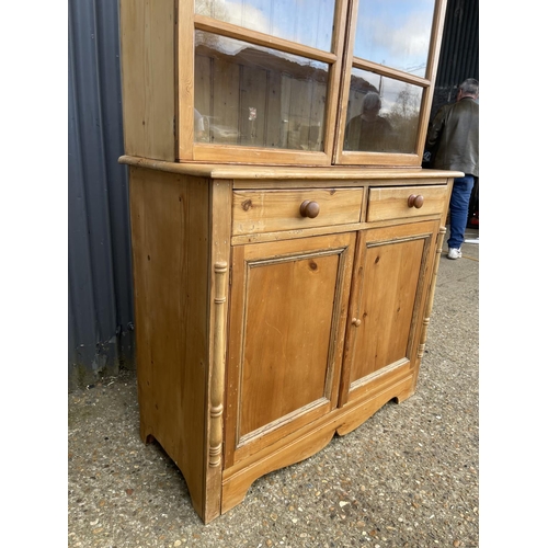 46 - A continental style pine dresser with glazed top over two drawers and two cupboard doors 110x45 x 20... 