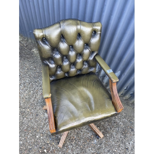 51 - A green chesterfield style leather swivel desk chair