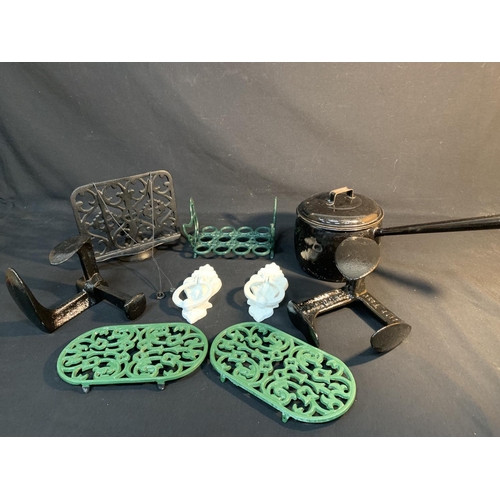 568 - Enamel pan, shoe lasts, trivets, book rack and door knockers