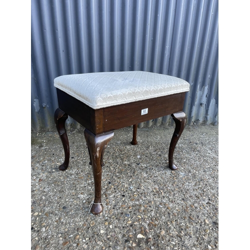 63 - A mahogany piano stool with lift up seat