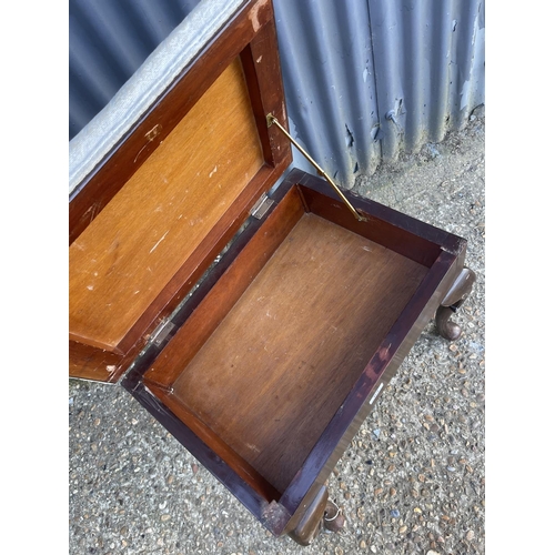 63 - A mahogany piano stool with lift up seat