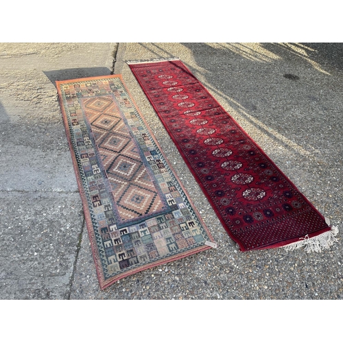 66 - An oriental runner rug together with another runner (larger 275x70)