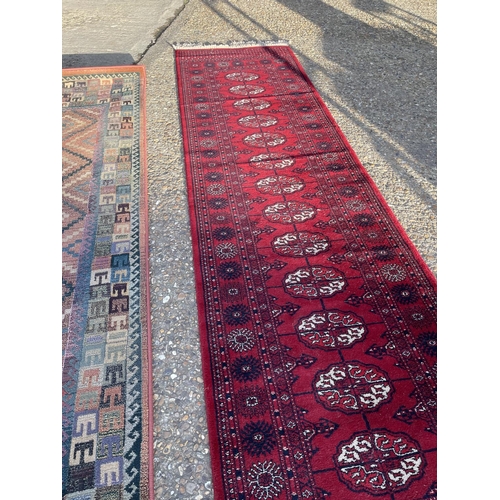 66 - An oriental runner rug together with another runner (larger 275x70)