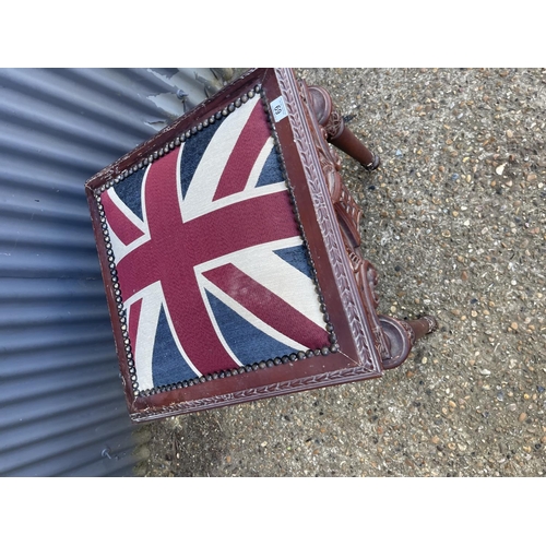 69 - An ormate carved window seat stool with Union Jack upholstered top 57 x57x64