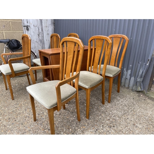 74 - A TEAK DROP LEAF DINING TABLE AND SIX CHAIRS BY MEREDEW