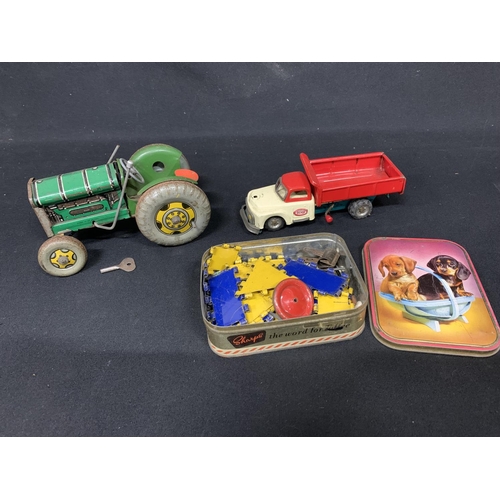 824 - Clockwork tractor, dump truck and tin of Meccano pieces