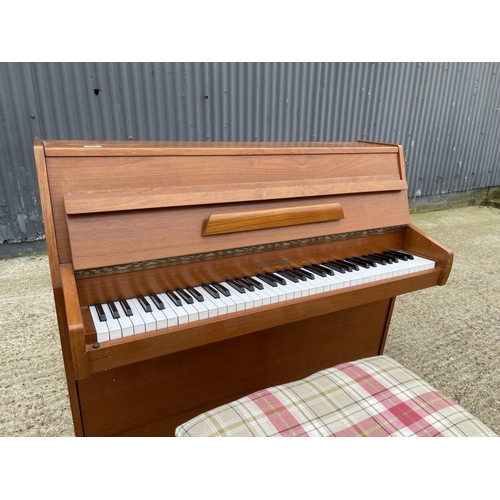 94 - A teak cased Zender piano and stool