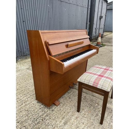 94 - A teak cased Zender piano and stool