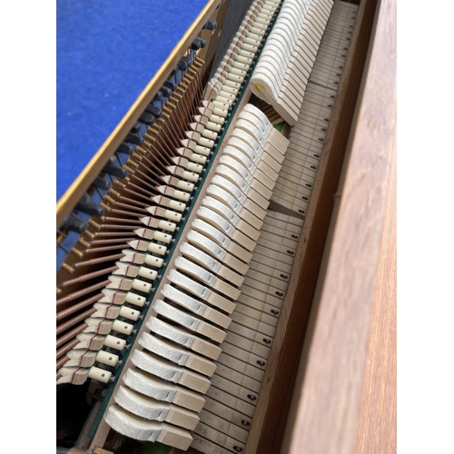 94 - A teak cased Zender piano and stool