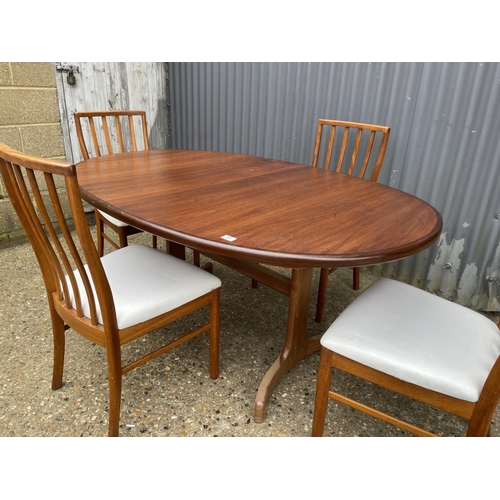 97 - A g plan extending teak oval dining table together with a set of four mid century teak dining chairs