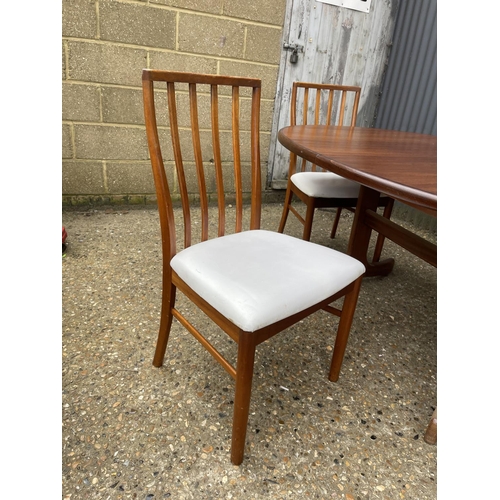 97 - A g plan extending teak oval dining table together with a set of four mid century teak dining chairs