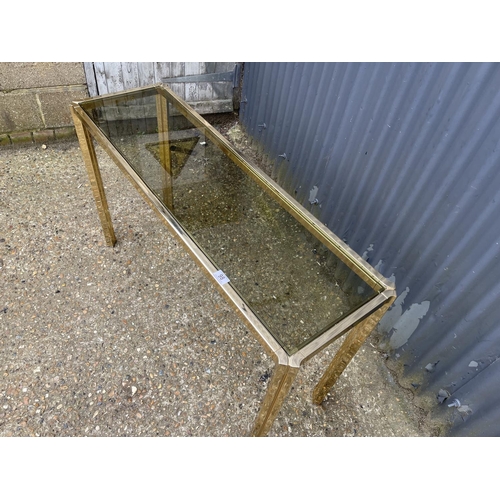 98 - An Italian style brass and smoked glass console table 115x30x105