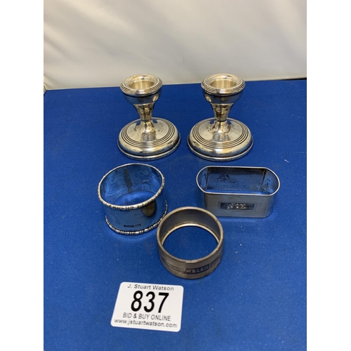 837 - Three Hallmarked Silver Napkin Rings, 2.14 ozt and pair of Hallmarked Silver Candlesticks height 6 c... 