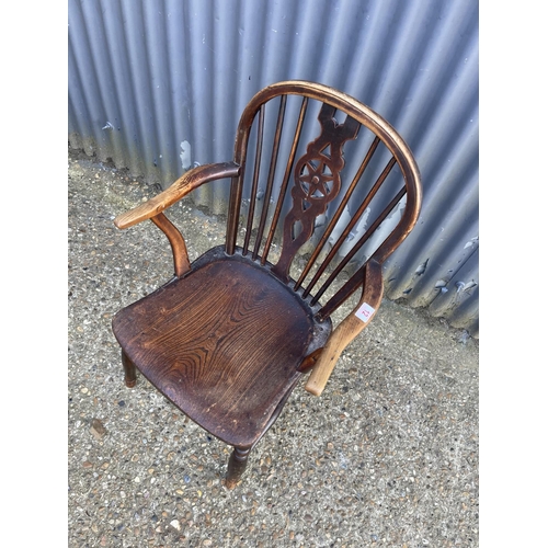 12 - An antique wheel-back carver chair