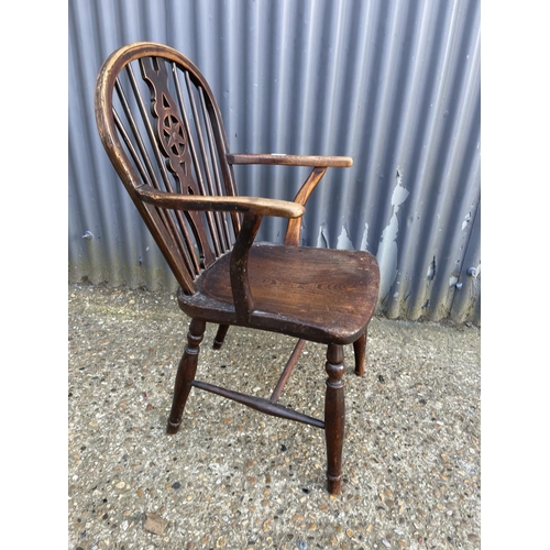 12 - An antique wheel-back carver chair