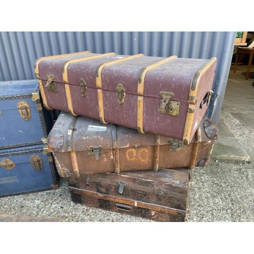 13 - A vintage military tin trunk together with five other vintage travelling trunks